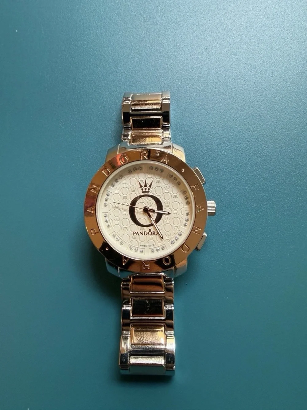 Wristwatch on teal background